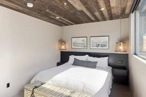 a bedroom with a bed and a bench in it at Zion loft with canyon views - unit 2 in Springdale