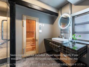a bathroom with a sink and a mirror at Sansuikyo Machiya House in Kanazawa +55 photos