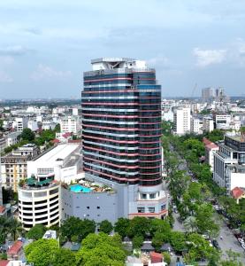 a tall building in the middle of a city at Melia Hanoi in Hanoi