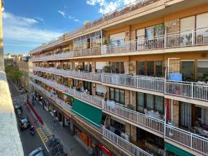 an apartment building with balconies on a city street at Stay U-nique Apartments Torrent in Barcelona