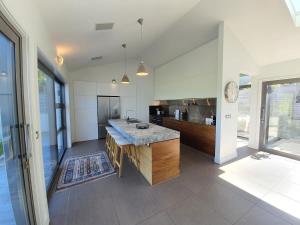 a kitchen with a large island in the middle at Private Retreat - Stunning Lake & Mountain Views in Queenstown