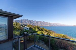 a view of the water from the balcony of a house at Private Retreat - Stunning Lake & Mountain Views in Queenstown