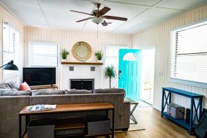 a living room with a couch and a ceiling fan at Mid-Century 1bd House - Beach Gear - 5min Walk to Beach in Clearwater Beach
