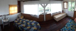 um quarto com uma cama e um banco num quarto em NoKo home em Mataiea