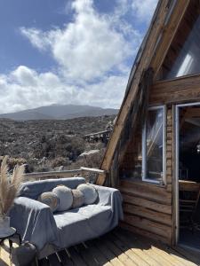 a bed sitting on the deck of a cabin at Eco Lodge La Ola Oculta in Trigo Blanco