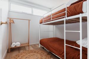 1 dormitorio con 2 literas y alfombra en Antalya Beach House, en Bridport
