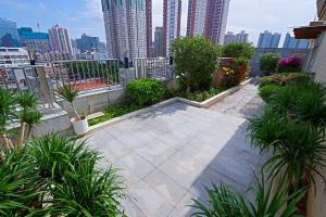 a patio with plants and a city in the background at Vienna International Hotel Shenzhen Shuibei in Shenzhen