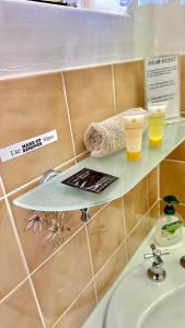 two glasses of beer on a shelf above a sink at Golden Grain Motor Inn in Tamworth