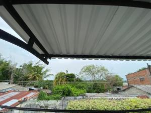 awning over a building with a view of roofs at Apartamento bustos in Puerto Triunfo