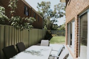 a patio with a table and chairs and a fence at Spacious Stay On Shamrock, Bendigo in Golden Square