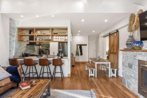 a living room and kitchen with a couch and a fireplace at Ice 3 in Thredbo