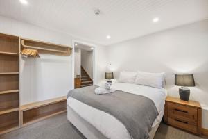 a bedroom with a bed with a stuffed animal on it at Ice 3 in Thredbo