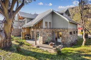 a stone house with a gray roof at Ice 3 in Thredbo