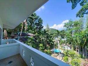 a balcony with a view of a resort at Prime Hill , Kathu Phuket / E2 in Phuket Town