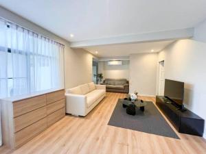 a living room with a couch and a television at Prime Hill , Kathu Phuket / E2 in Phuket Town