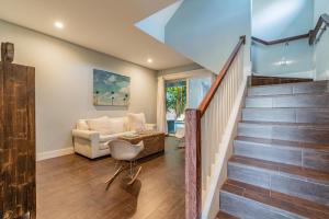 a living room with stairs and a couch at Playa Esmeralda Vacation Home Up To 14 People in Bradenton Beach