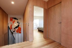 a hallway with a door leading to a bedroom at Rye Glass House - Architectural Escape in Rye +26 photos