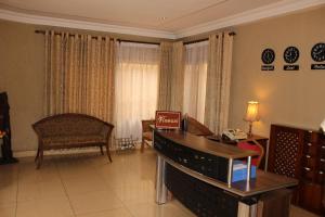 a living room with a piano and a chair at Hotel Residence Flamani in Lomé