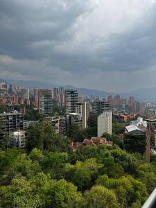 a view of a city with trees and buildings at Blux 1305 Poblado Medellín Colombia in Medellín