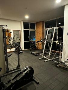 a gym with several treadmills and machines at Blux 1305 Poblado Medellín Colombia in Medellín