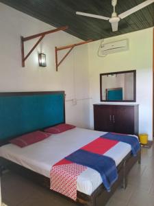 a bedroom with a large bed in a room at Ceylonica Beach Hotel in Negombo