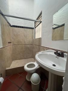 a bathroom with a toilet and a sink at Casa de campo La MariaCa in Utica +39 photos