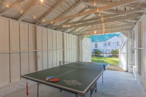 a ping pong table in a garage at Forest Hills Cottage in Augusta