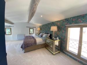 a bedroom with a bed and a window at Bastide de Peyloubet in Grasse +45 photos
