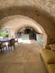 a kitchen and living room with a stone wall at Bastide de Peyloubet in Grasse