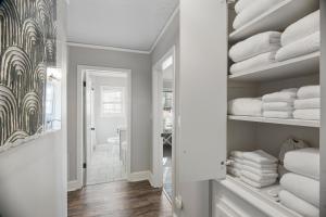 a room with a closet filled with white towels at Forest Hills Cottage in Augusta