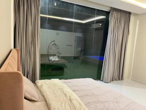 a bedroom with a bed and a glass wall at شاليه جود in Riyadh