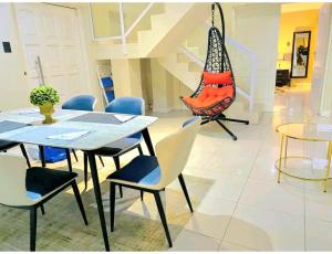 a dining room with a table and chairs and a staircase at 2 Private Bedrooms - homestay in Summerstrand