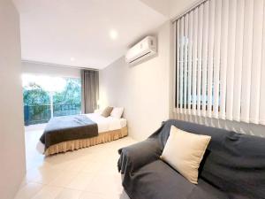 a bedroom with a bed and a couch in a room at Prime Hill , Kathu Phuket / F3 in Phuket Town