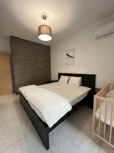 a bedroom with a large bed in a room at Quiet simple brand new luxury apartment by the sea in Athens