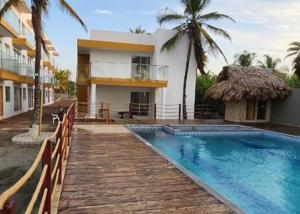 a resort with a swimming pool and a building at Apto PB Palmar de los vientos in San Bernardo del Viento