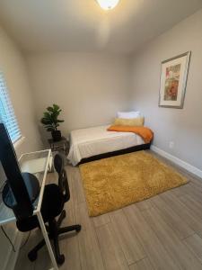 a bedroom with a bed and a desk and a chair at The Cove Downtown in Sacramento
