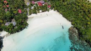 an aerial view of a beach with turquoise water at Sera Beach Dive Resort in Kododa