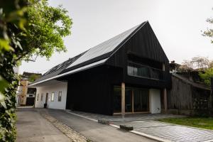 a black house with a gambrel roof at V22 - Premium Apartements in Ljubljana