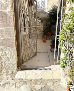 an entrance to a stone house with an open door at Secret House Andrea in Primošten