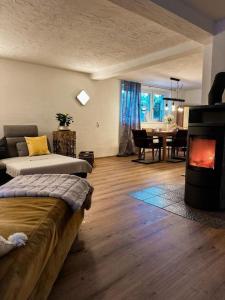 a living room with a bed and a fireplace at Sunway Lounge in Maishofen