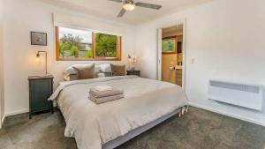 a bedroom with a large bed and a window at The Birkdale with Heated Pool by Ready Set Stay - BYO Linen and Towels in Sunset Strip