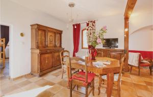a dining room with a table with a vase of flowers at Lovely Apartment In Les Salles-du-gardon With Kitchen in Soustelle