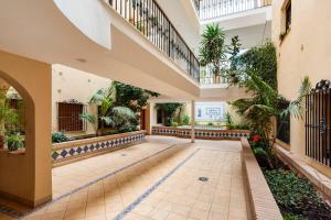 an indoor courtyard with a staircase and plants at Tu hogar en Ronda, la Ciudad Soñada in Ronda