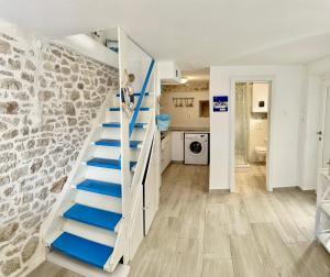 a staircase in a room with a stone wall at Secret House Andrea in Primošten +19 photos