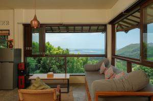 a living room with a large window with a view at Ashtari - Sky, Sea & Nature in Kuta Lombok +33 photos