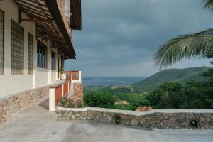 a house with a view of the mountains at Ashtari - Sky, Sea & Nature in Kuta Lombok