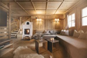 a living room with a couch and a fireplace at Sporer-Alm in Rohrberg