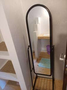 a mirror next to a stairway in a room at Happiness House in Shela