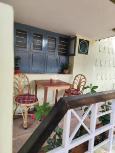 a patio with a table and chairs and blue cabinets at Park View in Mysore