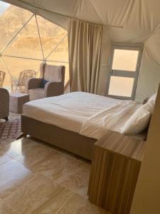 a bedroom with a bed in a tent at Moon Rum Camp in Wadi Rum